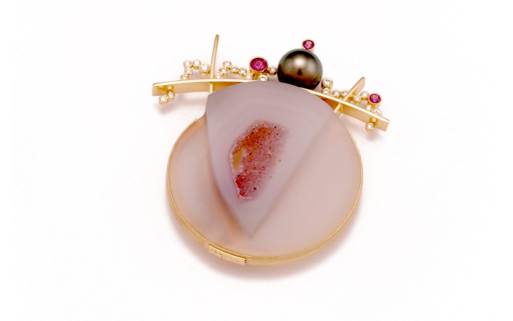 8047B - 18 karat gold fabricated brooch set with carved agate .68cttw. Diamonds, .70cttw. Rhodolite Garnets and 12mm Tahitian Pearl (17.6g) Price Upon Request